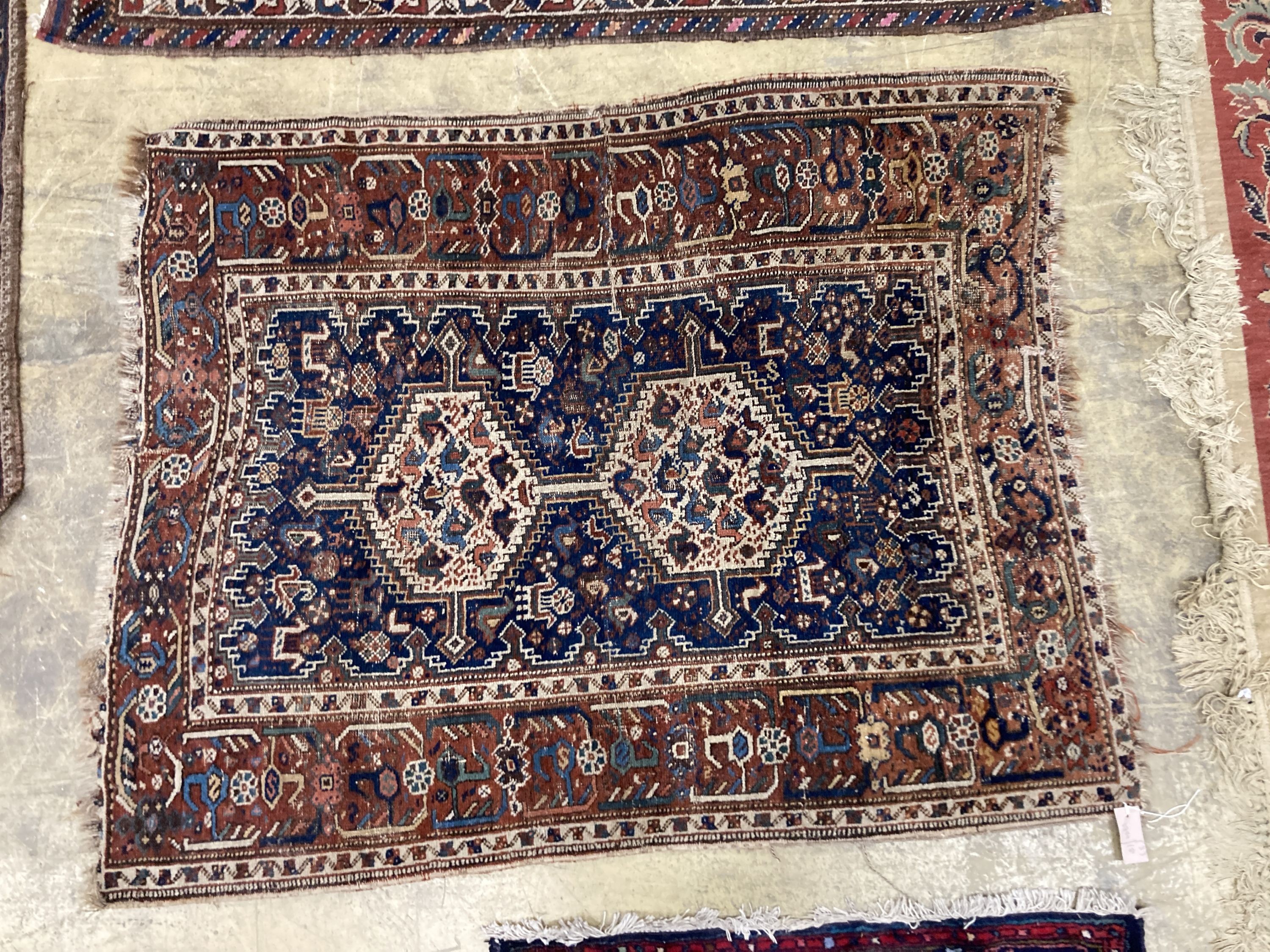 Three antique Caucasian blue ground rugs, largest 154 x 114 cms.